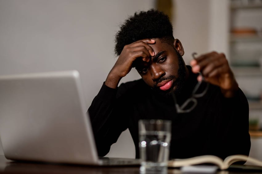a-worried-multicultural-businessman-is-sitting-at-2023-11-27-05-08-18-utc-min